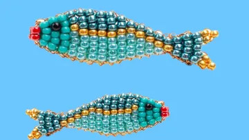 Two beaded fish on a blue background.
