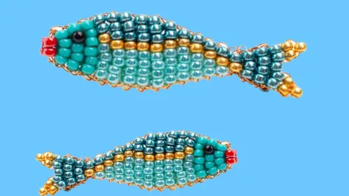 Two beaded fish on a blue background.