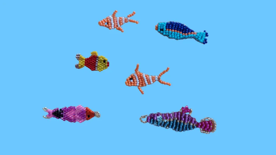 Bunte Perlenfische auf blauem Hintergrund.