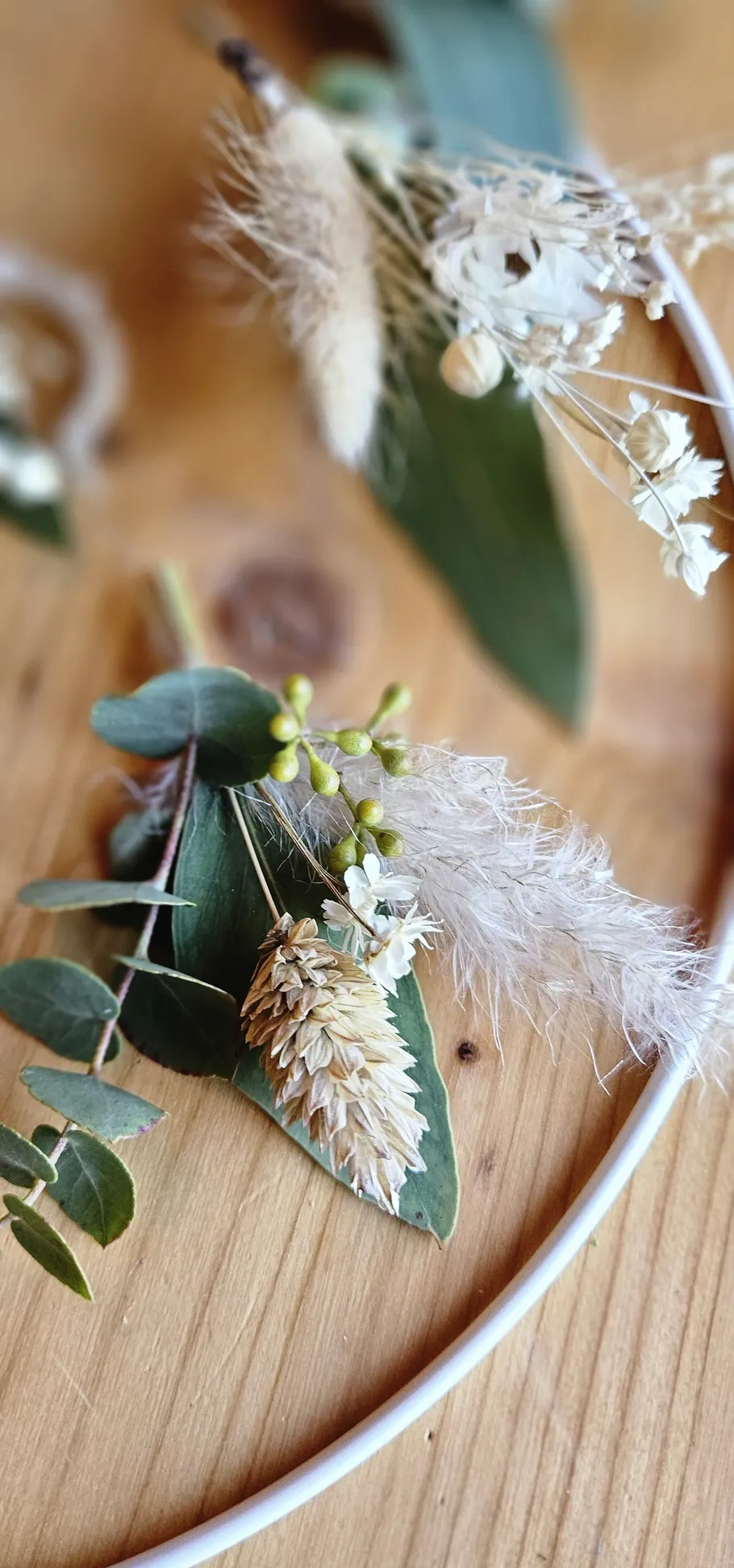 Dried floral arrangement on wooden surface.