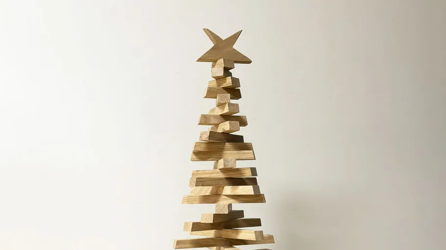 Wooden Christmas tree with star in minimal style.