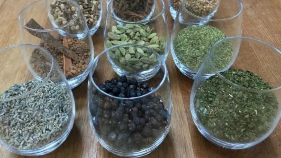 Glasses filled with various herbs and spices.