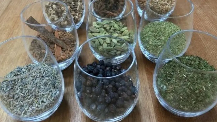 Various spices in glasses on a table.