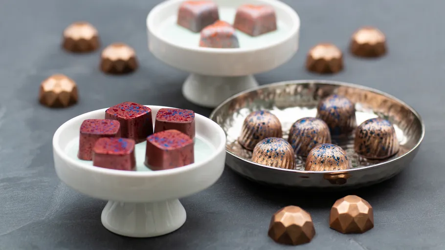 Assorted chocolates displayed on plates.
