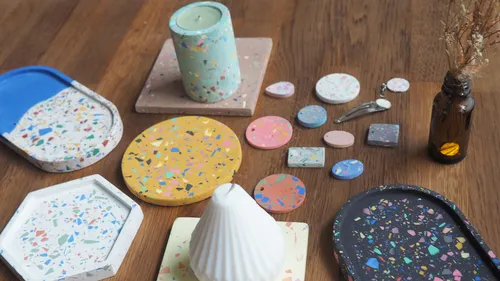 Colorful terrazzo items on wooden surface.