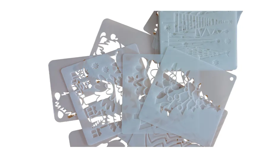 Plastic stencils with festive cutouts, layered together.