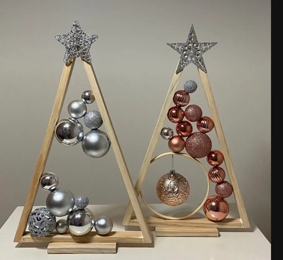 Christmas tree ornaments on wooden stands.