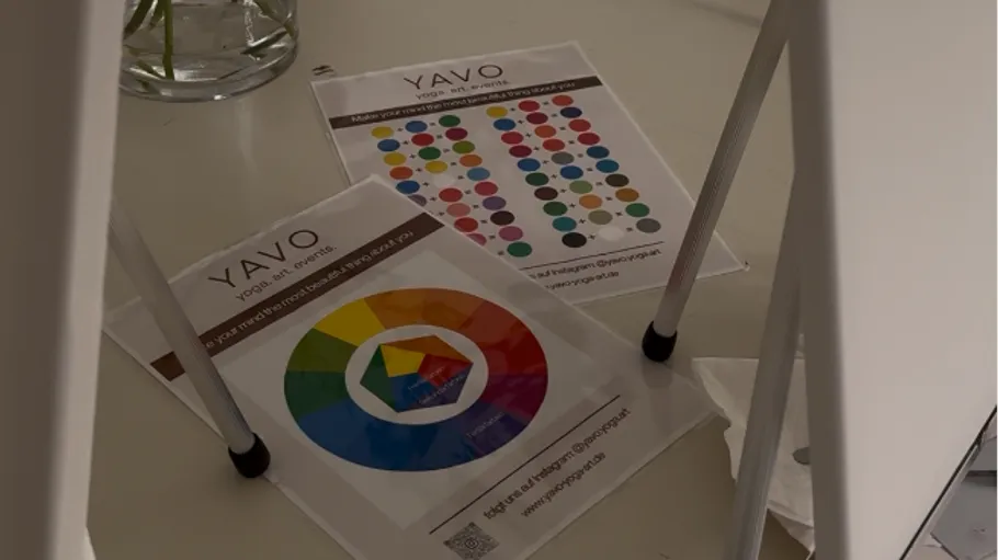 Color charts on the floor beneath a chair.