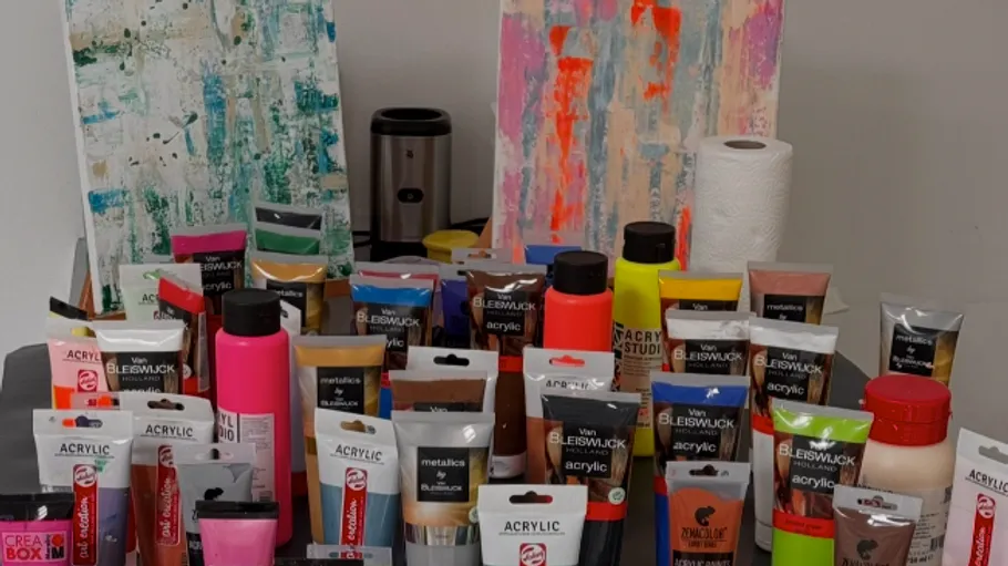 Acrylic paints displayed with abstract paintings.