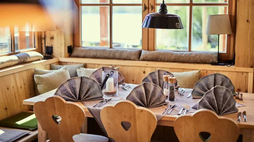Rustic dining table with folded napkins.