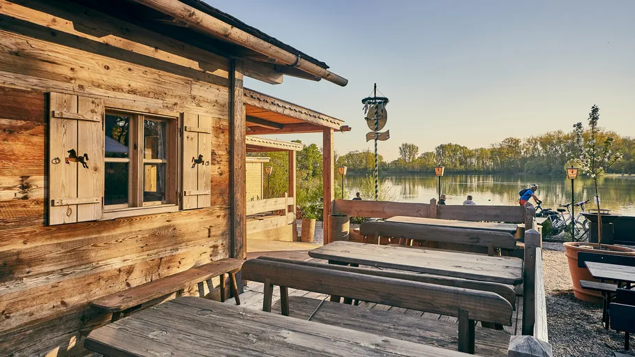 Wooden terrace overlooking a serene lake.
