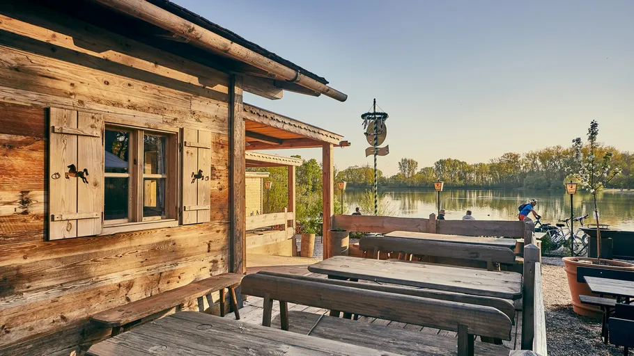 Rustic cabin terrace overlooking a tranquil lake.