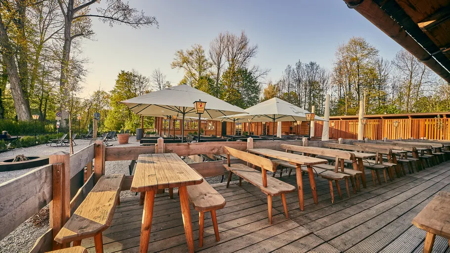 Wooden tables in outdoor beer garden setting.