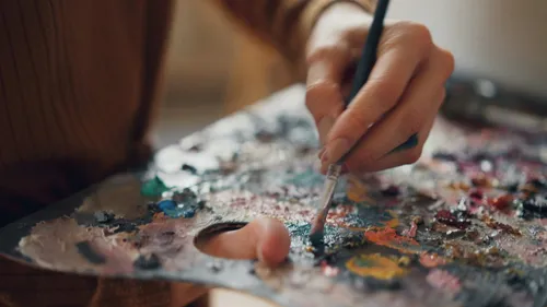 Hand painting with brush on palette.