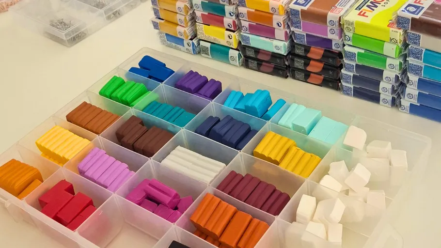Colorful polymer clay blocks organized in a container.