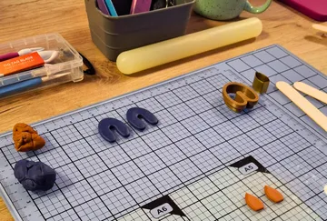 Crafting table with colorful clay and tools.