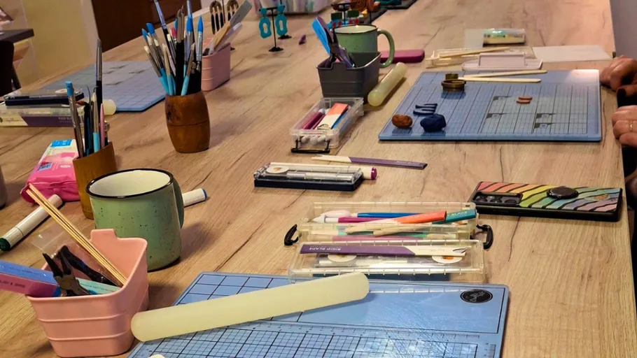 Crafting tools organized on wooden table.