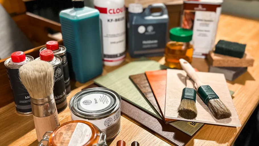 Wood finishing supplies arranged on a table.