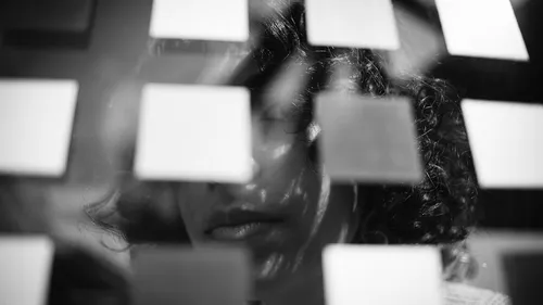 Person's face obscured by sticky notes.