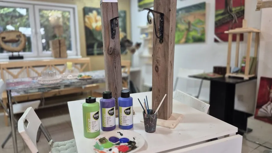Art studio with paint and wooden posts.