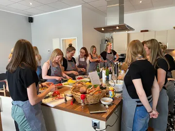 Chefs prepare meals together in a modern kitchen environment.