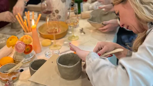 Woman crafting pottery in a class setting.