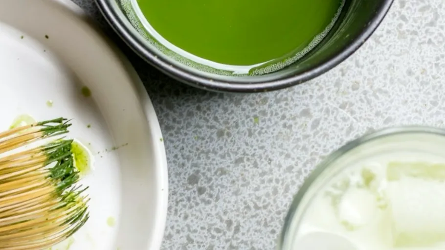 Matcha-Schale und Schneebesen auf einem Tisch.