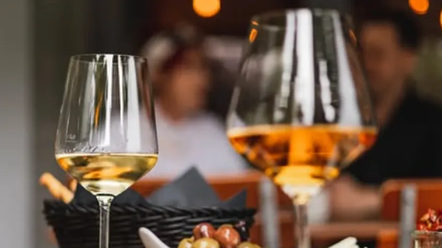 Two wine glasses on a dining table.