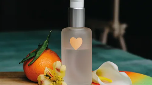 Bottle with heart, flowers, and orange.