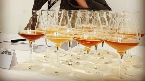Glasses of beer displayed on a table.