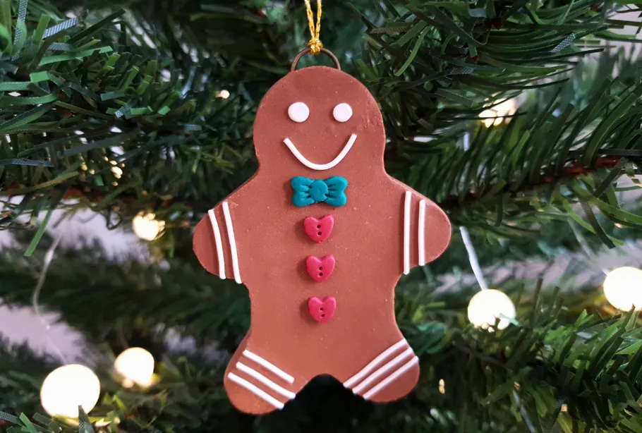 Gingerbread ornament hanging on Christmas tree.