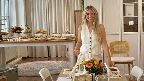 Woman smiling in elegantly decorated room.