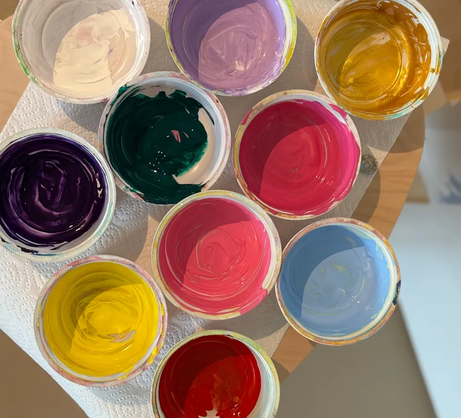 Colorful paint containers on paper towel.
