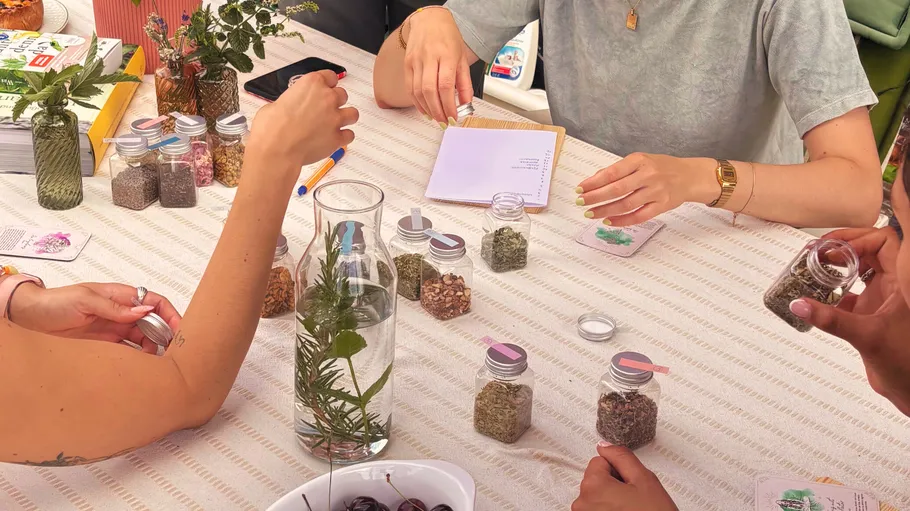 People discussing herbs and plants at a table.