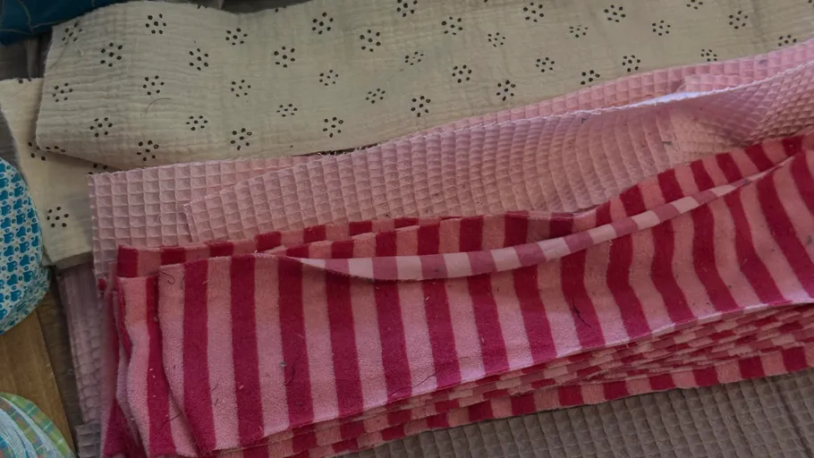 Stacked folded towels with various patterns.