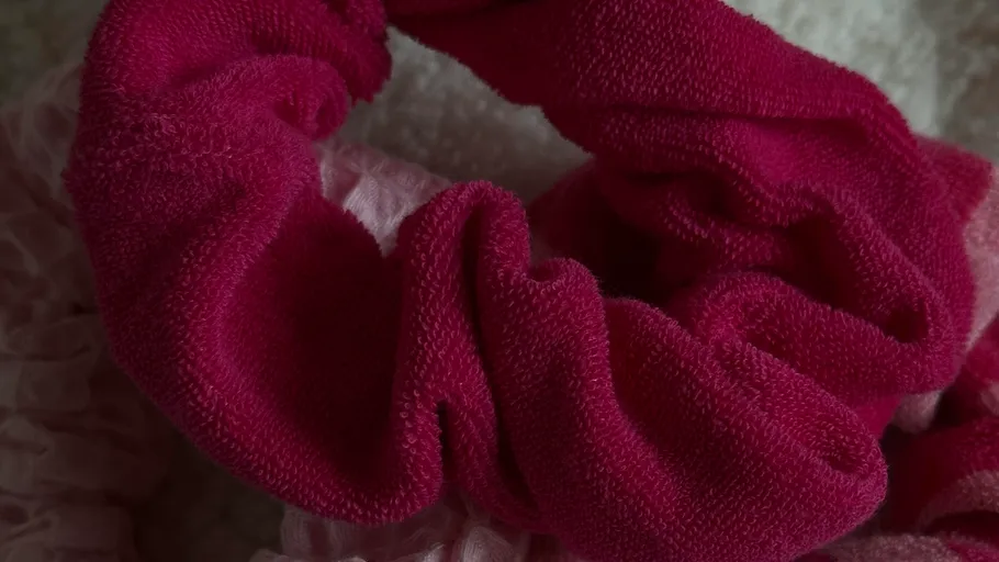 Close-up of a pink fabric scrunchie.