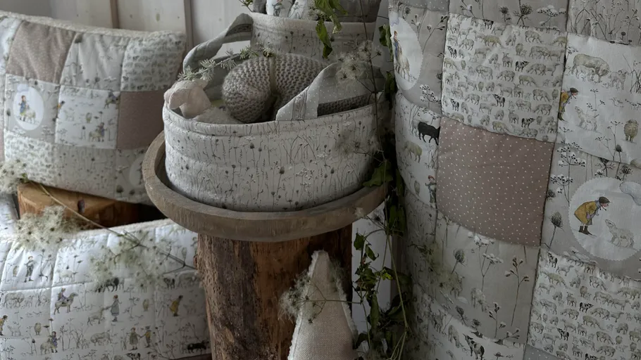 Patchwork bedding with nature-themed designs on display.