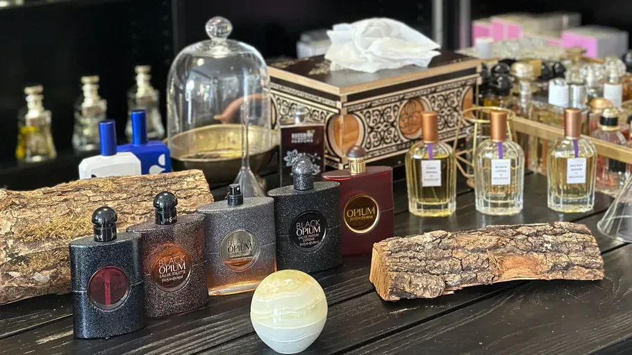 Perfume bottles arranged on a wooden table.