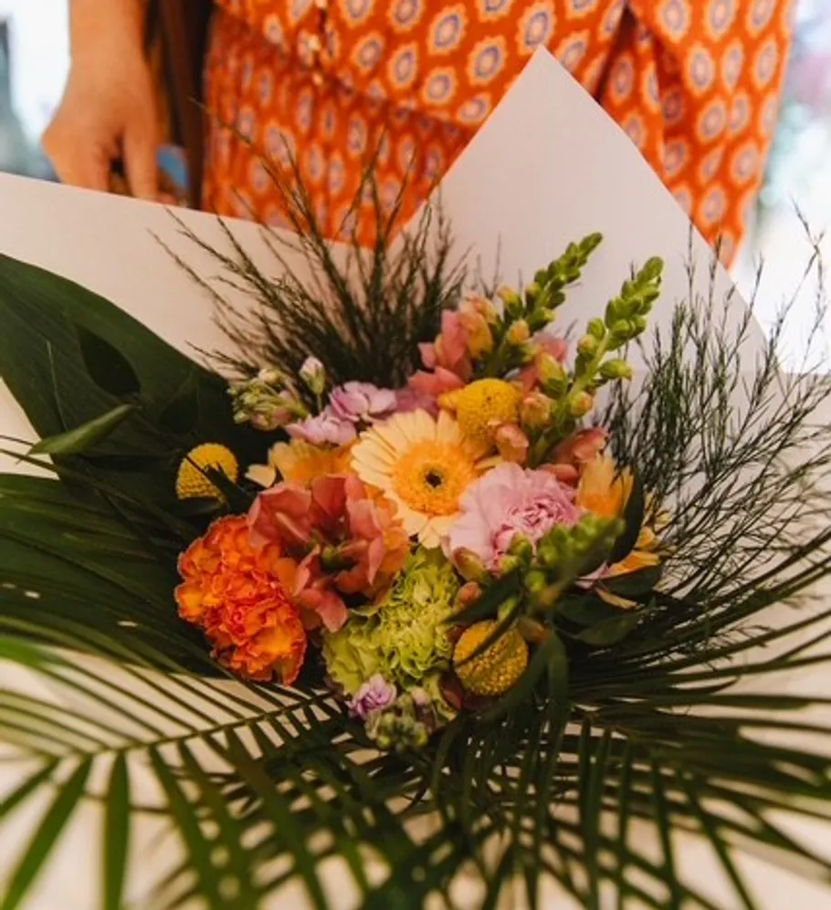 Vibrant flower bouquet with leafy greens.