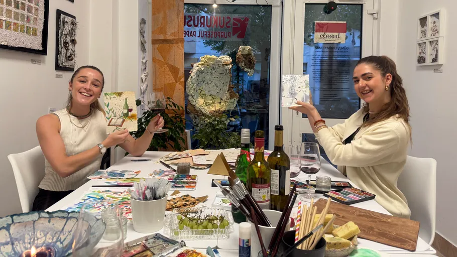 Two women painting at an art workshop.