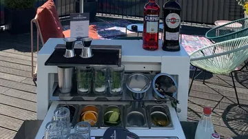 Outdoor bar setup with bottles and mixers.