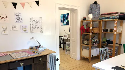 Craft room with fabric and sewing equipment.
