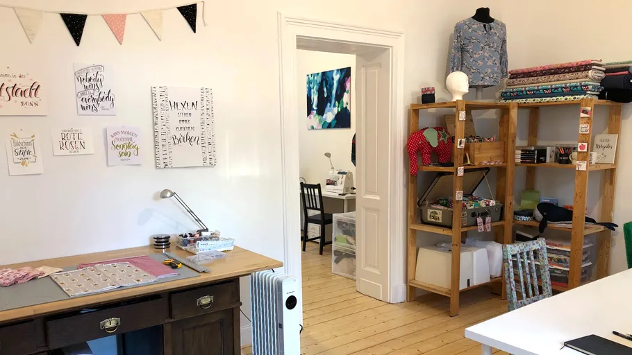 Craft room with fabric and sewing equipment.