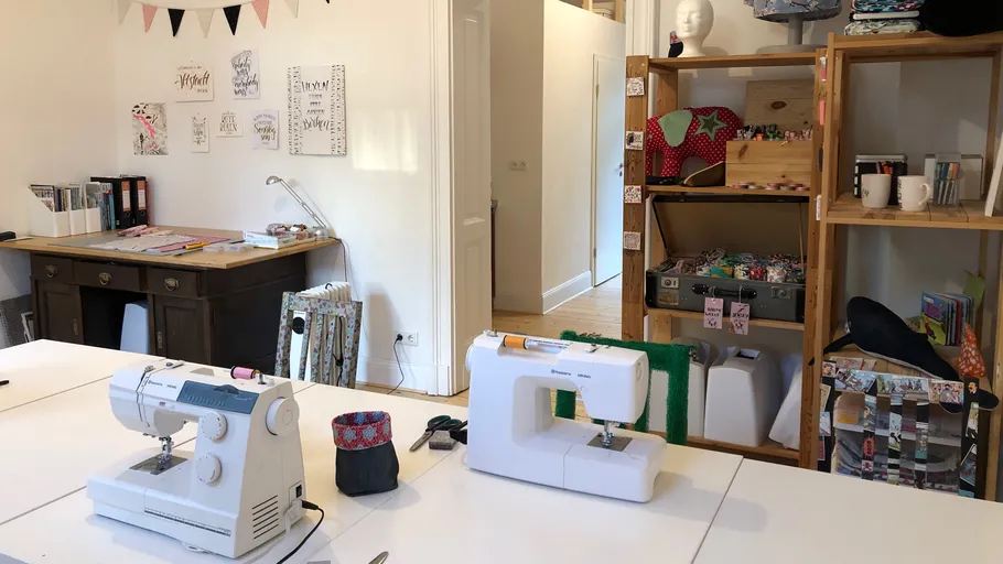 Sewing machines on tables in craft room.