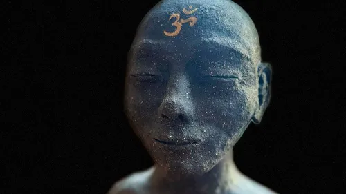 Stone statue with Om symbol on forehead.