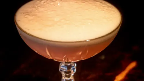 Schaumiger Cocktail in einem eleganten Glas.