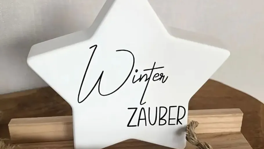 White star-shaped decoration with "Winter Zauber" text.