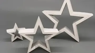 Three white star-shaped decorations on gray background.