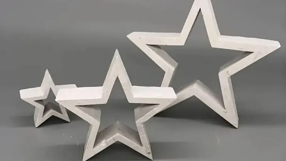 Three white star-shaped decorations on gray background.