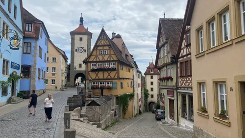 Timber-framed buildings on cobblestone street.